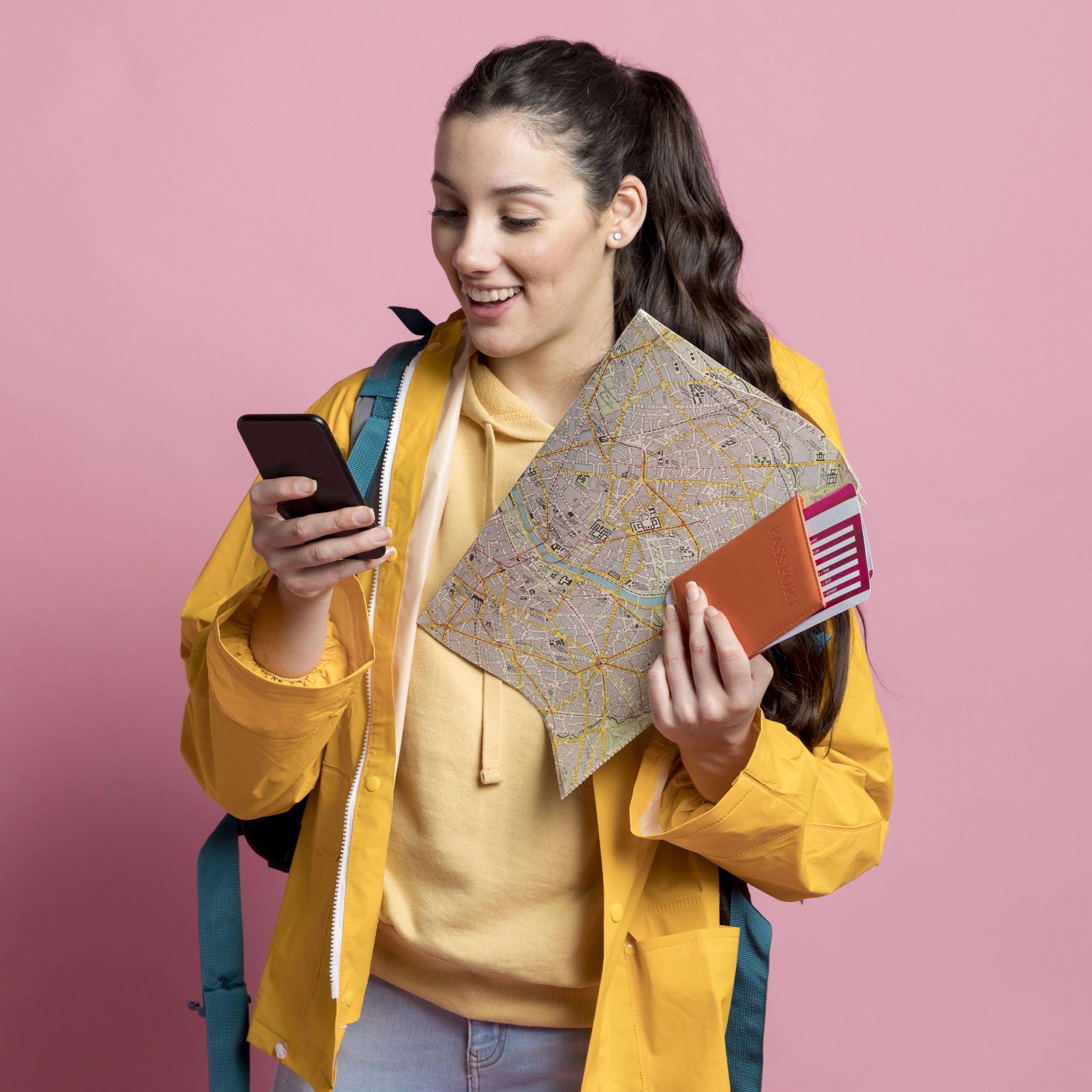 smiley-woman-checking-her-phone-while-holding-map-her-passport
