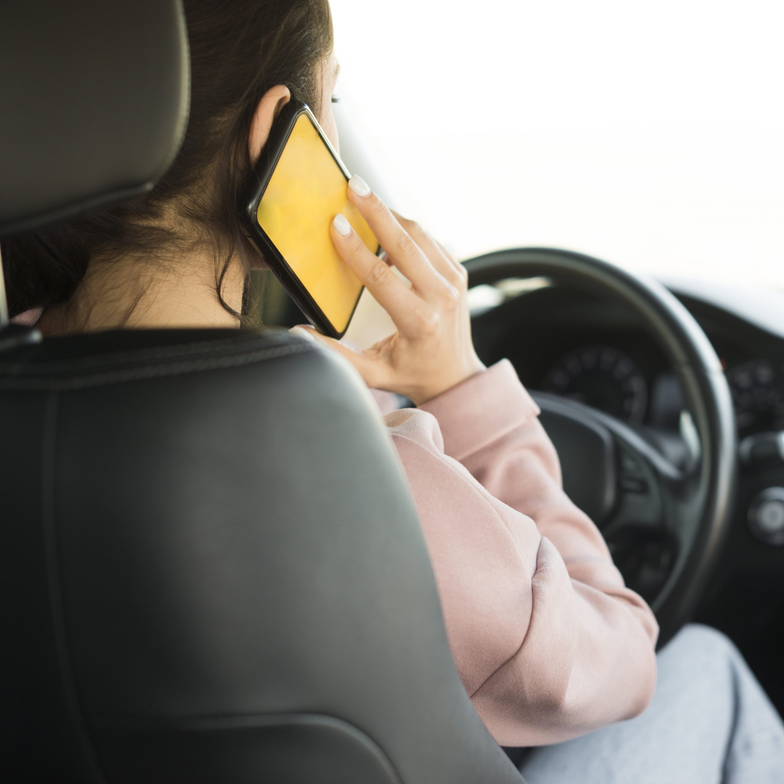 woman-steering-wheel-talking-phone